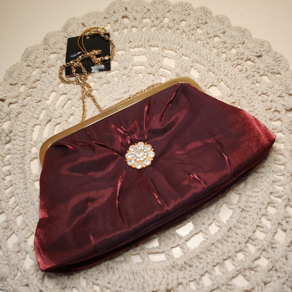 Elegant Burgundy Clutch with Gold Chain And Metal Charm Embellishment in Center